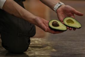 avacado in the hands of a man