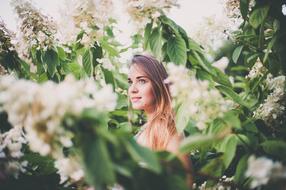 girl among flowering trees in a blurry background