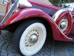 red car with a white wheel