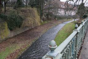 the river flowing in the park near the bridge