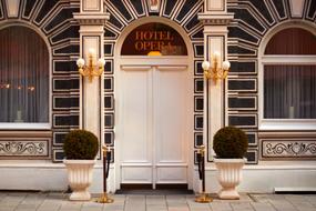 Facade of the hotel with door, decorations and plants
