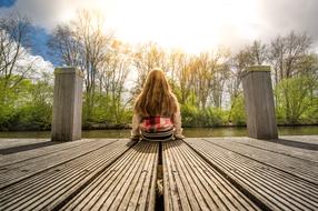 girl with long hair on a wooden pier