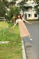 Girl in Fashion dress balancing on path