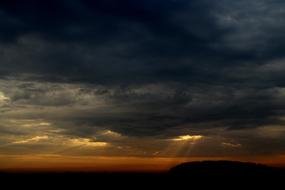 sunset with a silhouette of a field