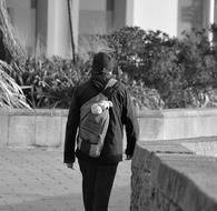 Man with backpack walking away