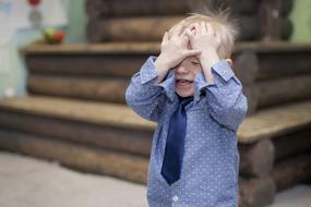 Boy Covering Face