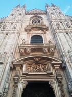 Low angle shot of the beautiful, old Duomo in Milan, Italy, under the blue sky