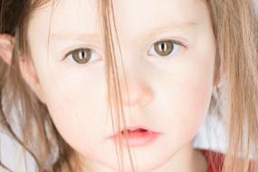 photo of a little girl with disheveled hair