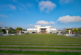 Landscape with the Staatstheater and plants in Darmstadt, Germany, under the blue sky with clouds