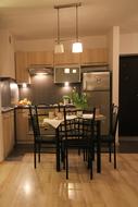 Interior of the apartment kitchen with table, chairs, in lights