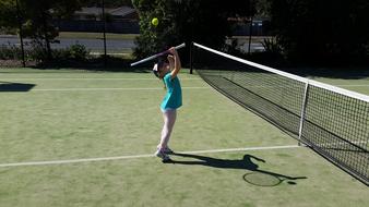 little tennis player on the court on a sunny day