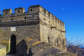 Beautiful, old Great Wall among the plants, under the blue sky, on the landscape