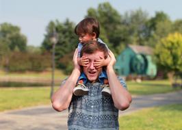 little boy on father's shoulders