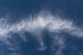 line of fluffy clouds on blue sky