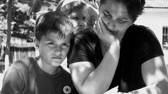 black and white photo of a pensive woman with children