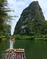 landscape of a green mountain with a lake and a boat