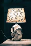 Beautiful, patterned, shiny lamp, with the cable, at black background