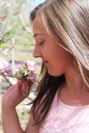 profile portrait of a girl with flowers in the garden