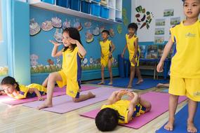 Children, doing exercises on the colorful mats