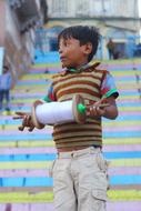 Cute boy with the kite, on the colorful stairs