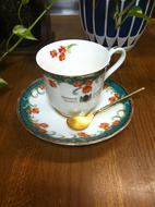 white cup with gold spoon