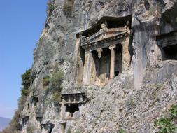 Beautiful temple of Lycia, with pillars and plants, in Fethiye, Turkey, under the blue sky