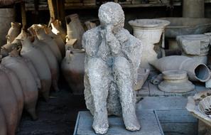 Old stone man in Pompey, among the pots