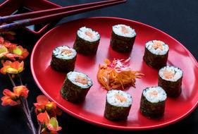 Delicious rolls on a red plate