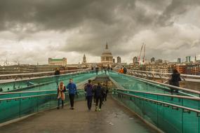 People on Bridge in view of city at cloudy day, uk, england, London