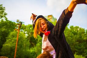 Beautiful, blonde girl, on the Festival of Colors, near the green trees, in Moscow, Russia, in 2017