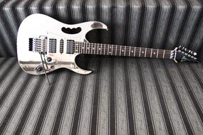 guitar on the couch in black and white background