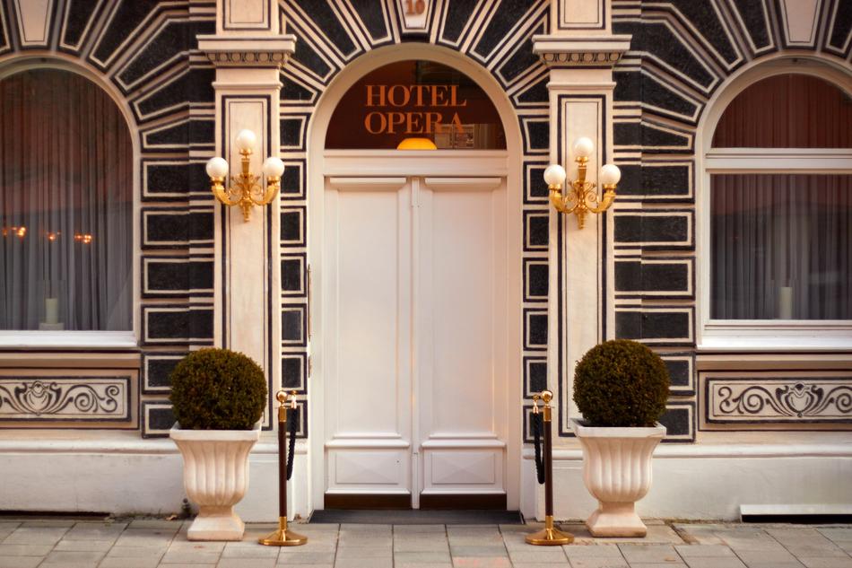 Facade of the hotel with door, decorations and plants