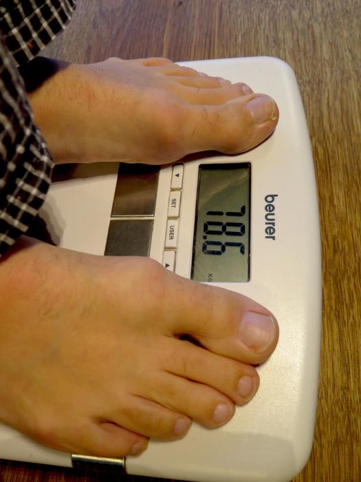 Person on the electric scales, with the numbers