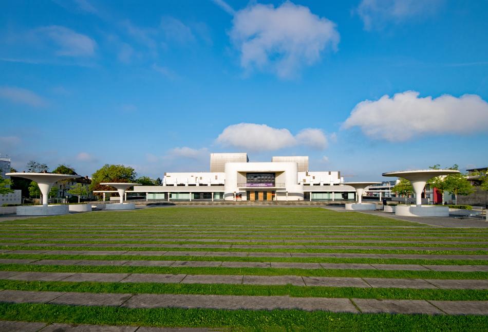 Landscape with the Staatstheater and plants in Darmstadt, Germany, under the blue sky with clouds