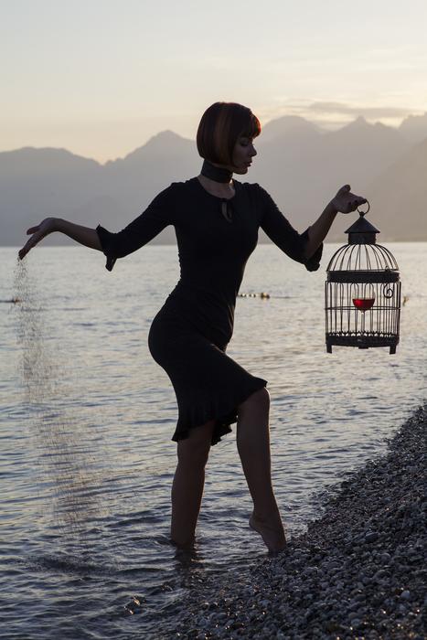 abstract photo of girl with a cage in her hand