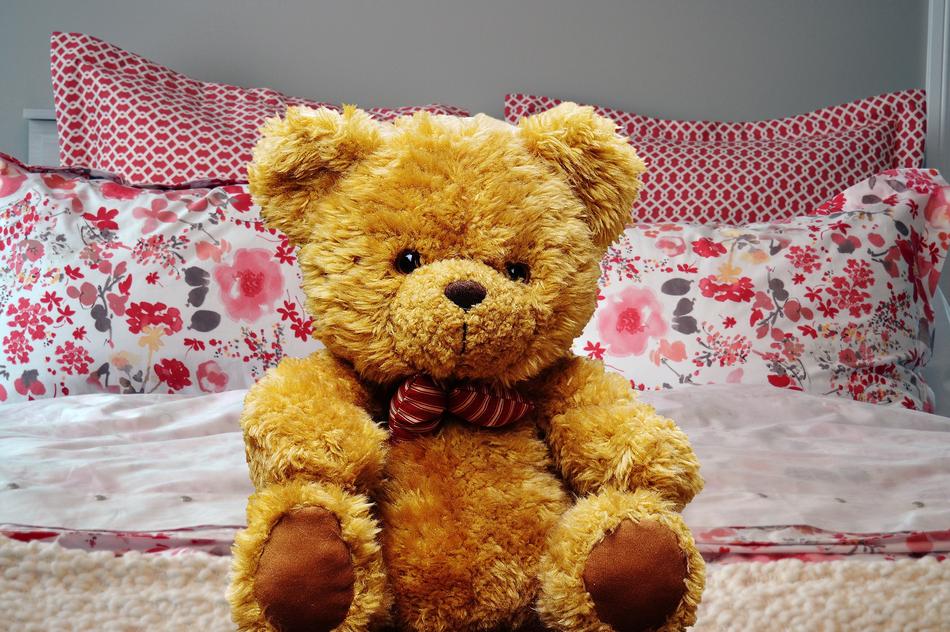 brown teddy bear on the bed