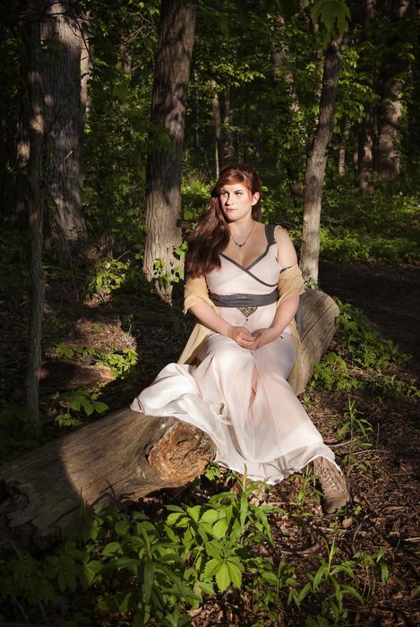 girl in a white dress sitting in a garden
