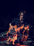 Campfire and Man with Guitar