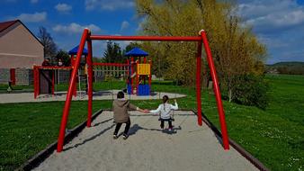 Mother and Child daughter on swing at fall