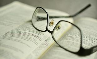 reading glasses lie on an open book