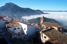 Beautiful panoramic view of the town, with the colorful buildings and bell tower, on the mountains, in white clouds