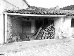 black-white stacked firewood in an old house in Spain