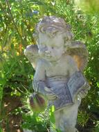 baby Angel with open book, Statue in garden