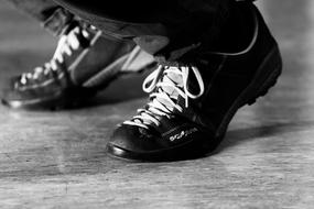 Black and white photo of the shiny shoes of the man, in light