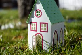 Colorful model of the house among the green grass