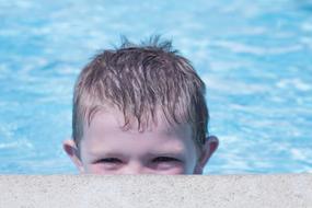 little boy in the pool close up