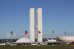 Landscape with the buildings and colorful flags in Brasilia, Brazil, under the blue sky