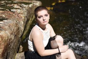 girl posing near the river on a sunny day