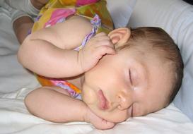 newborn baby sleeps in the crib