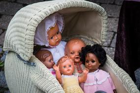 Close-up of the shiny dolls in the pram